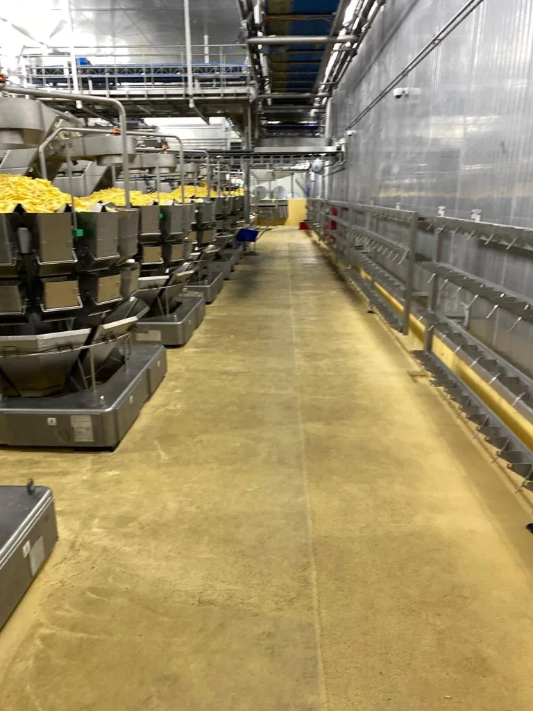Yellow Ucrete BC4 polyurethane cement floor in the production area of a potato processor