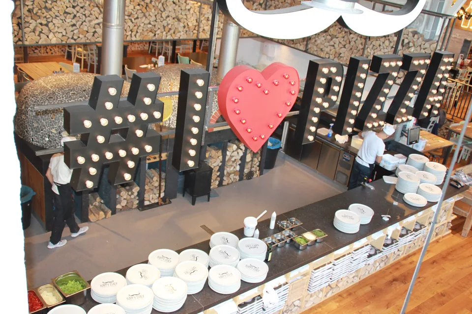 Quartz floor in a hotel restaurant with illuminated letters and a buffet