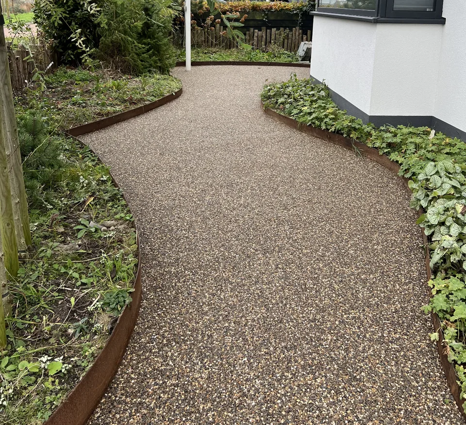 Terradec gravel surface as a garden path between corten steel borders